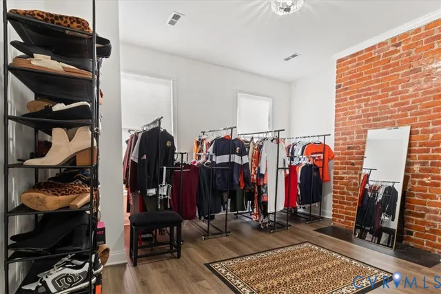 a view of walk in closet with clothes and shoes