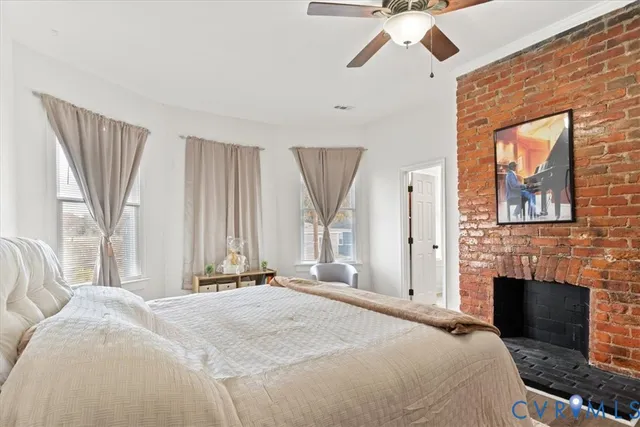 a spacious bedroom with a bed and a fireplace