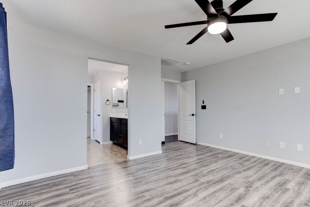 7724 Vibrant Thread Court Las Vegas, NV 89149 - Photo 22 of 43 A well-proportioned bedroom with resilient flooring, offering direct access to a private bath.
