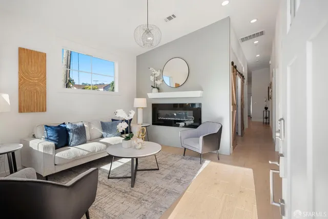 a living room with furniture a fireplace and a flat screen tv