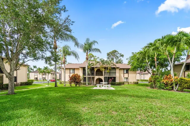 a front view of a house with a yard table and chairs