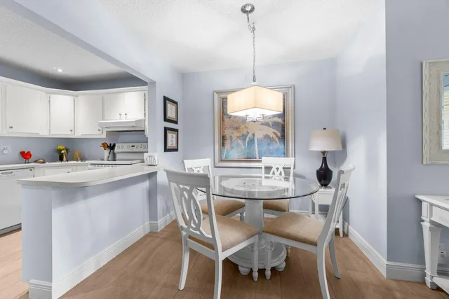 a kitchen with kitchen island granite countertop a sink a center island and cabinets