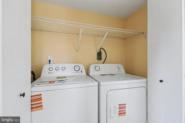a backyard of house with wooden fence and large trees