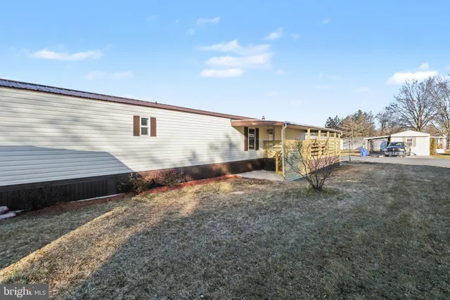 a view of a blue house with a yard