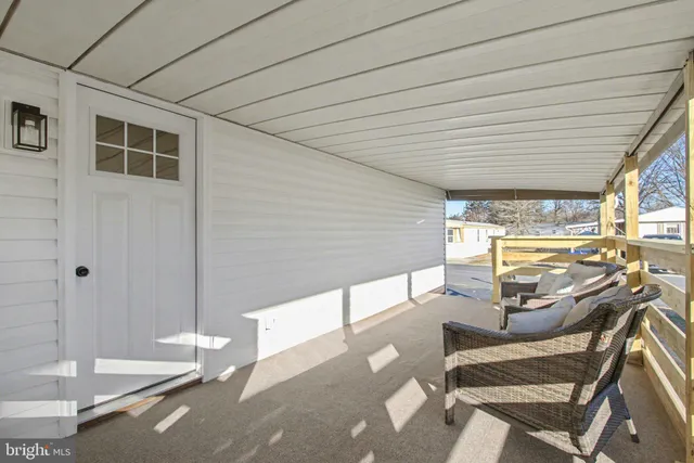 a living room with furniture a air conditioner vent and a window