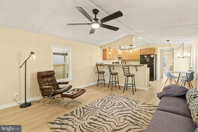 a kitchen with stainless steel appliances kitchen island granite countertop a table and chairs in it