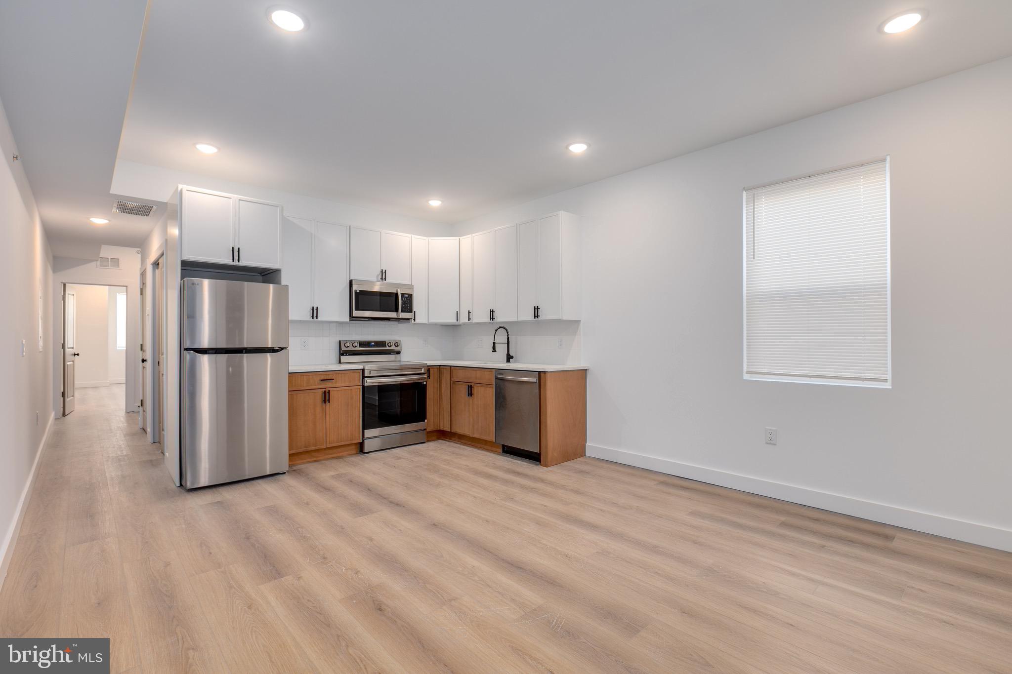 2203 North 7th Street, Unit 3 Philadelphia, PA 19133 - Photo 1 of 13 a kitchen with stainless steel appliances a refrigerator sink and cabinets