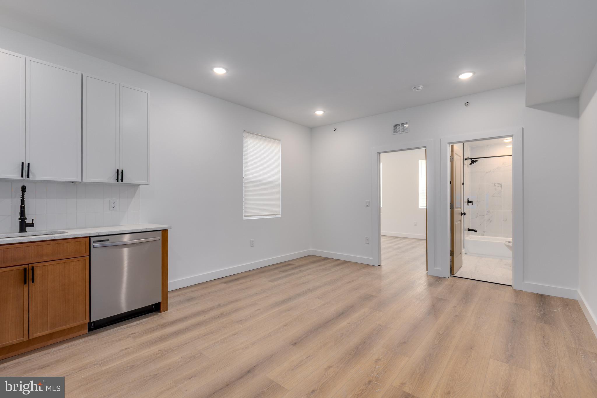 2203 North 7th Street, Unit 3 Philadelphia, PA 19133 - Photo 3 of 13 a view of a kitchen with wooden floor and electronic appliances