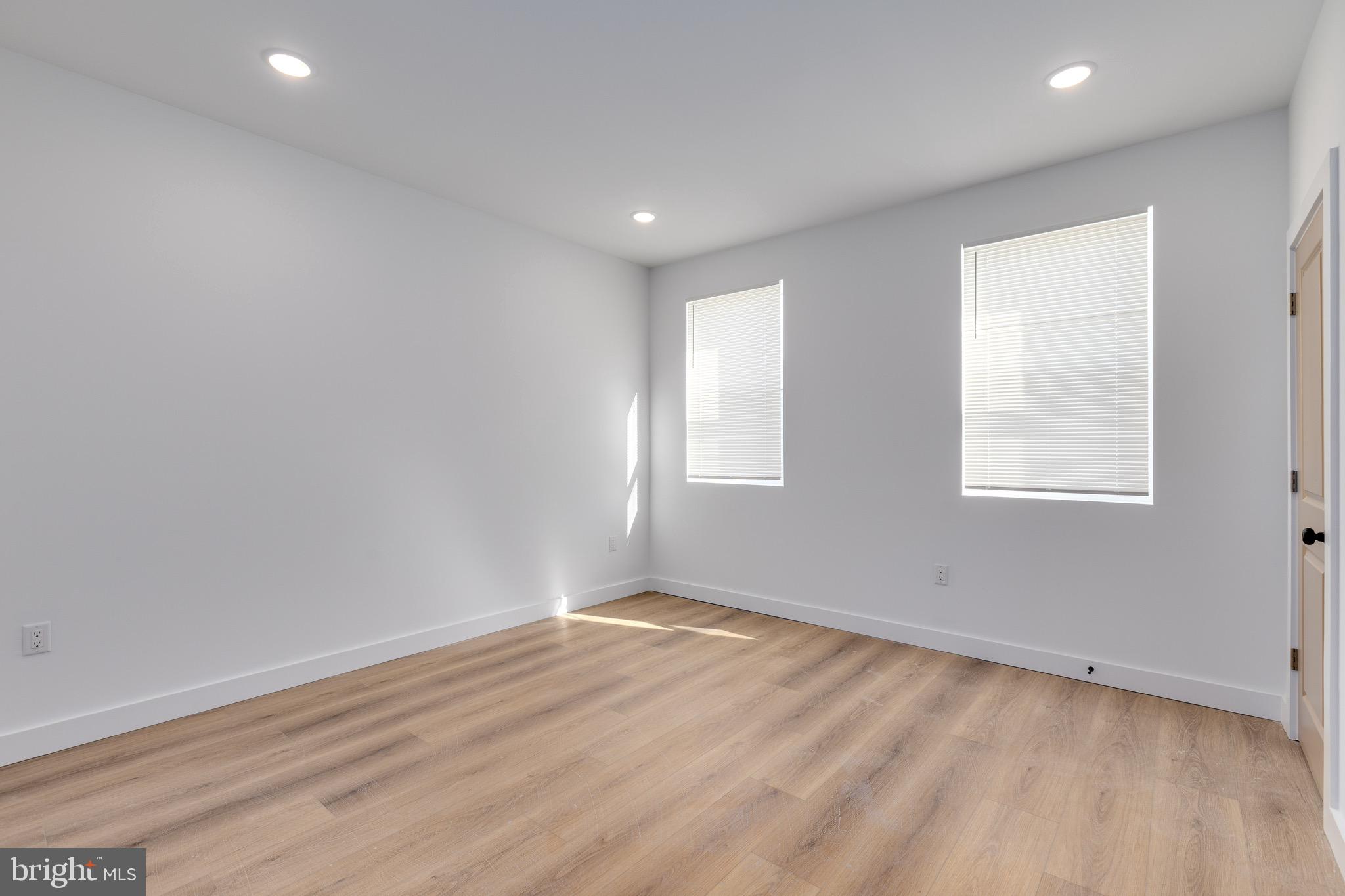 2203 North 7th Street, Unit 3 Philadelphia, PA 19133 - Photo 4 of 13 an empty room with wooden floor and windows