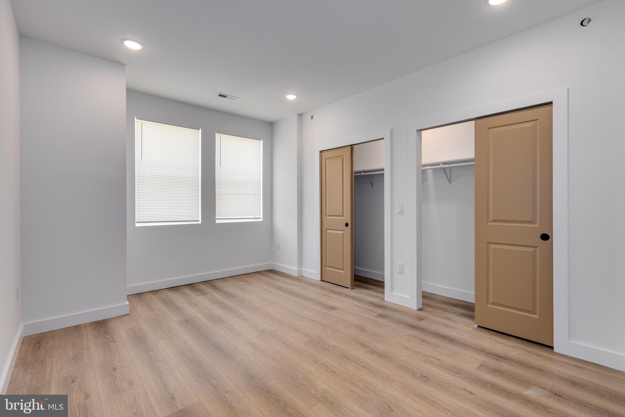 2203 North 7th Street, Unit 3 Philadelphia, PA 19133 - Photo 8 of 13 a view of an empty room with wooden floor and a window