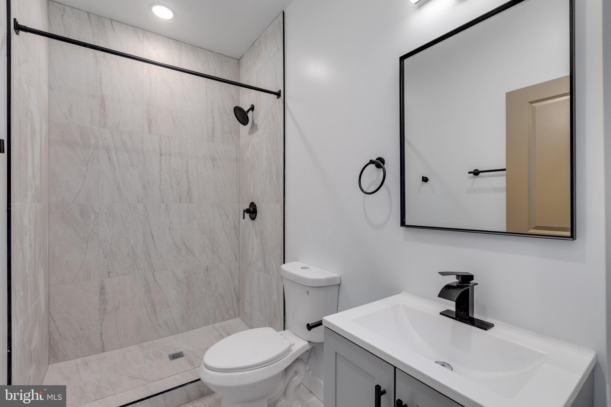 2203 North 7th Street, Unit 3 Philadelphia, PA 19133 - Photo 10 of 13 a bathroom with a sink a toilet and shower