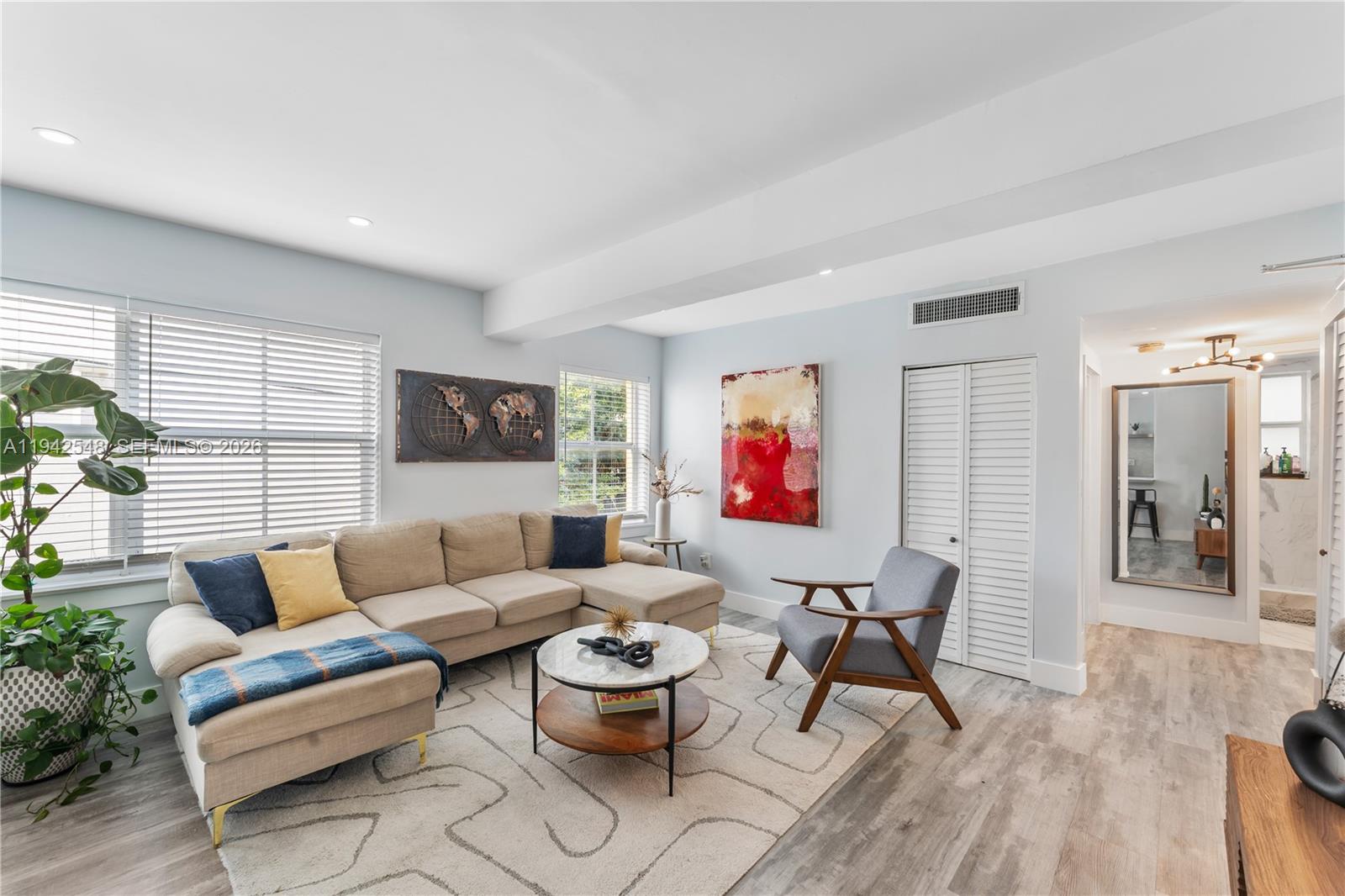 1308 Drexel Avenue, Unit 209 Miami Beach, FL 33139 - Photo 9 of 13 a living room with furniture and a wooden floor