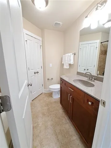 a spacious bathroom with a double vanity sink a mirror and a shower