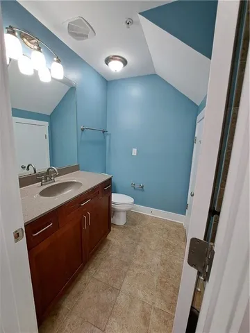 a bathroom with a sink a toilet and a mirror