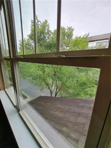 a view of a glass door with a yard from a window