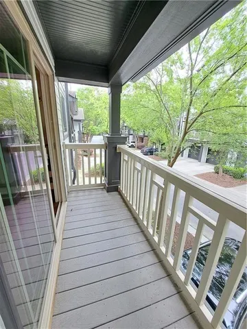 a view of a balcony with wooden floor