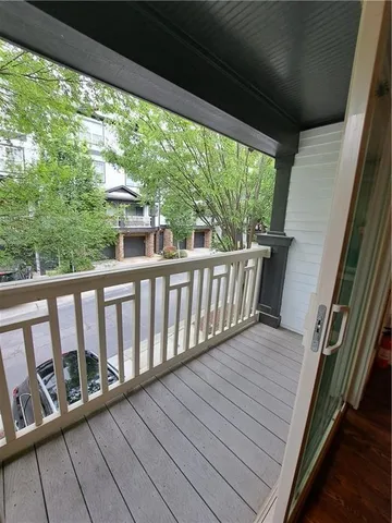 a view of balcony with wooden floor