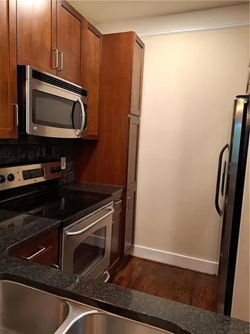a kitchen with a refrigerator stove and microwave