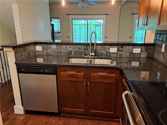 a view of a kitchen with a sink and cabinets