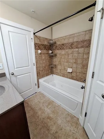 a bathroom with a shower and a bath tub