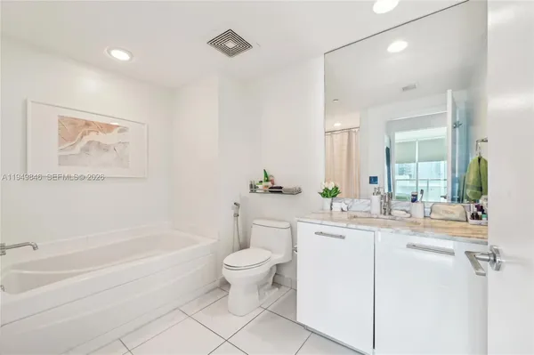 a bathroom with a sink a toilet and a bathtub