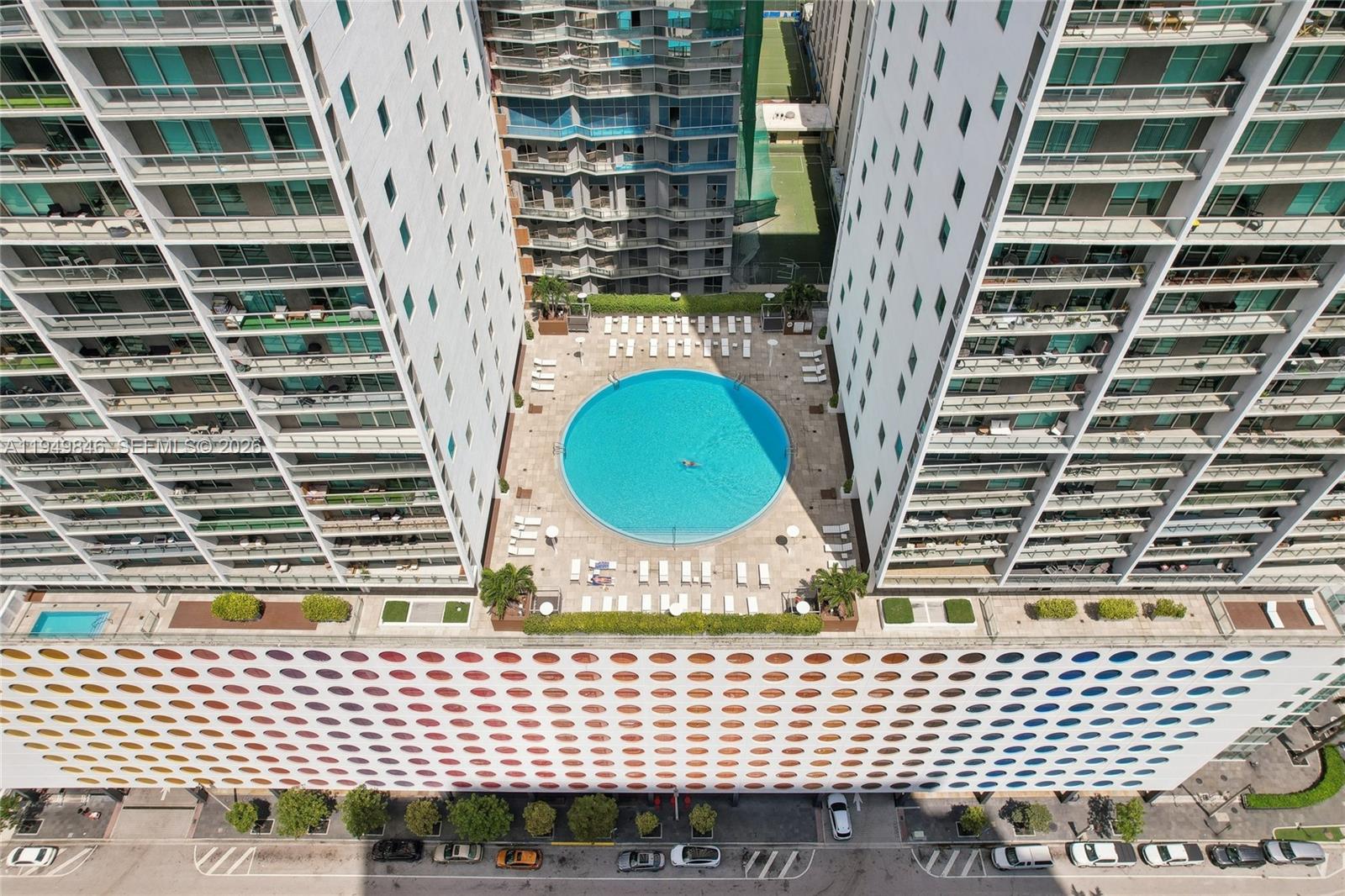 55 Southeast 6th Street, Unit 1608 Miami, FL 33131 - Photo 19 of 24 Aerial view of luxury Brickell high-rise surrounded by Miami River and downtown skyline.