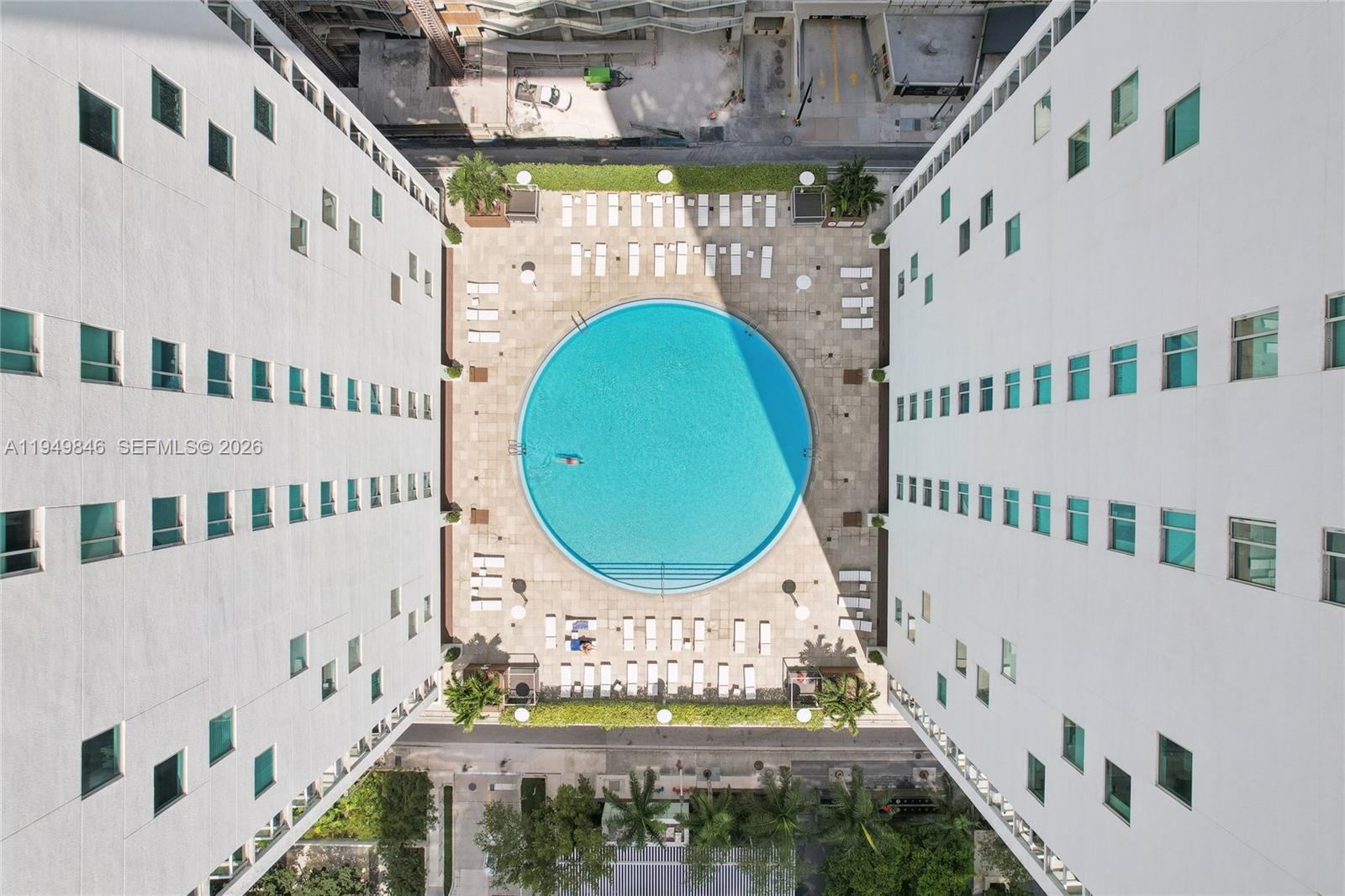 55 Southeast 6th Street, Unit 1608 Miami, FL 33131 - Photo 23 of 24 Drone view showcasing building’s pool deck, luxury amenities, and central Brickell location.