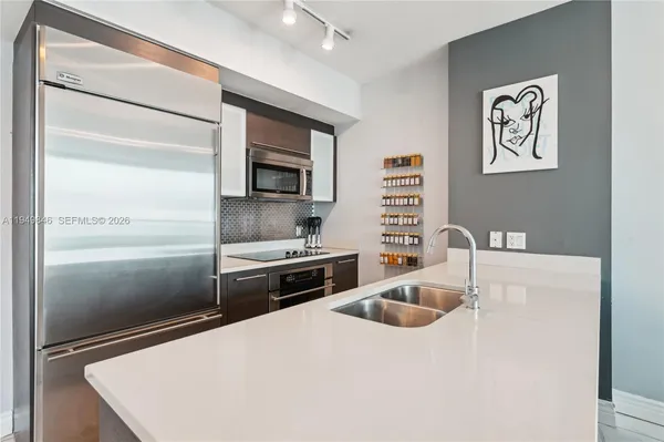 a kitchen with a refrigerator sink and stove