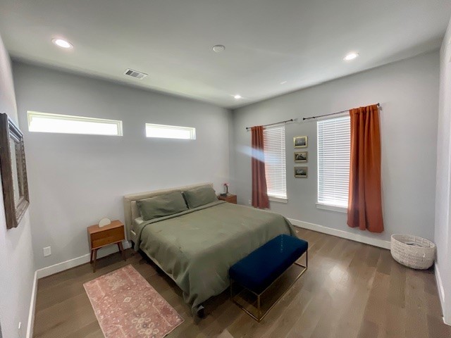 808 Fisher Street, Unit A Houston, TX 77018 - Photo 19 of 33 a bedroom with a bed and a night stand