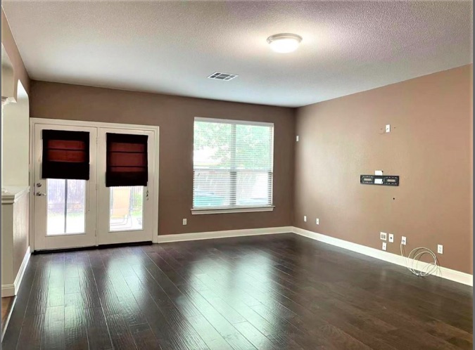 508 Tyree Road Cedar Park, TX 78613 - Photo 7 of 22 an empty room with wooden floor and windows
