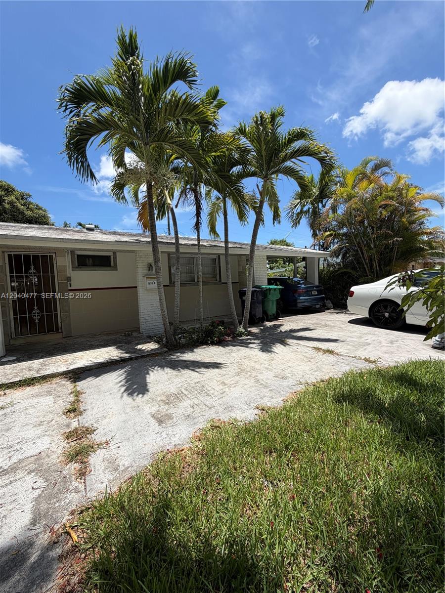 9110 Southwest 44th Street Miami, FL 33165 - Photo 4 of 18 a front view of a house with a yard and garage