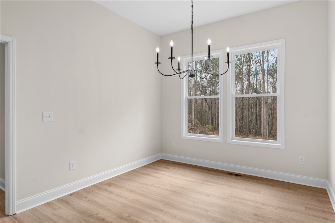 333 Lone Oak Road Anderson, SC 29621 - Photo 15 of 36 This bright space offers ample natural light and a charming chandelier, perfect for gathering.