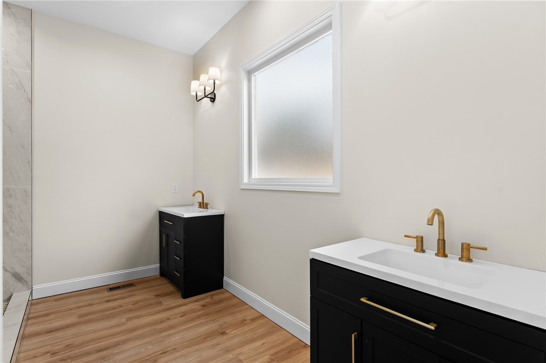 333 Lone Oak Road Anderson, SC 29621 - Photo 22 of 36 This spacious bathroom offers dual vanities, modern fixtures, and ample natural light.