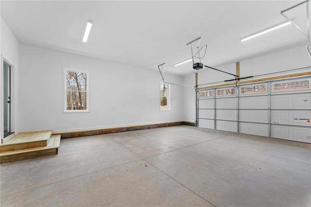 333 Lone Oak Road Anderson, SC 29621 - Photo 32 of 36 This spacious garage offers ample room for vehicles and storage, with natural light from the windows.