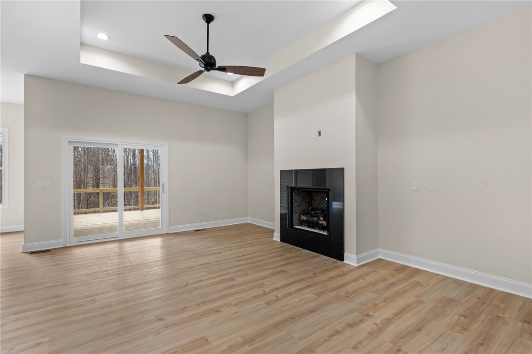 333 Lone Oak Road Anderson, SC 29621 - Photo 5 of 36 This bright living space features elegant flooring and a cozy fireplace, perfect for gathering.