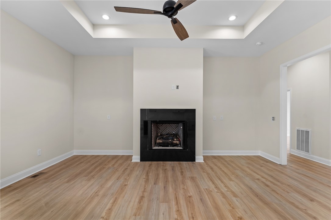 333 Lone Oak Road Anderson, SC 29621 - Photo 7 of 36 This inviting living space features warm flooring, a cozy fireplace, and recessed lighting.