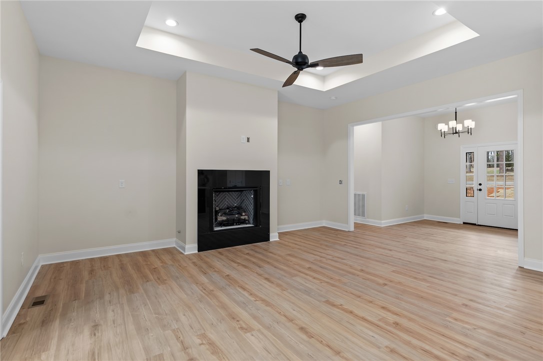 333 Lone Oak Road Anderson, SC 29621 - Photo 9 of 36 This expansive living space features durable flooring and a cozy fireplace, perfect for gatherings.