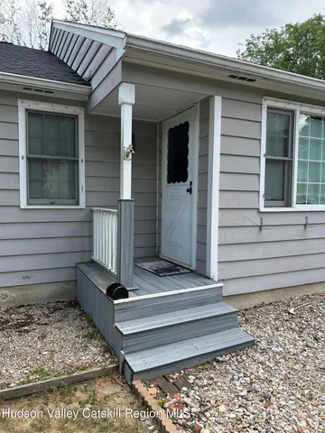 a front view of a house with stairs