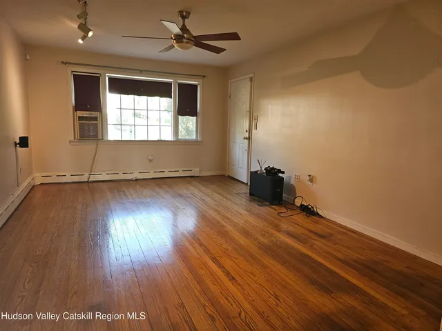 wooden floor in an empty room with a window