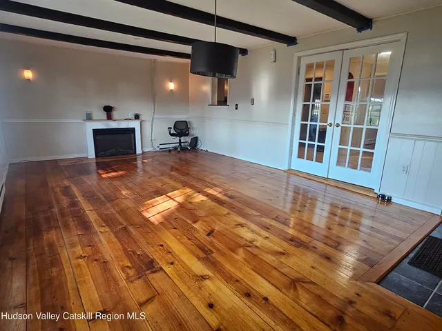 a view of a livingroom with furniture and an entryway