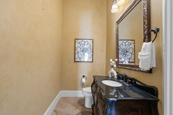 a view of a dining room with furniture and a chandelier