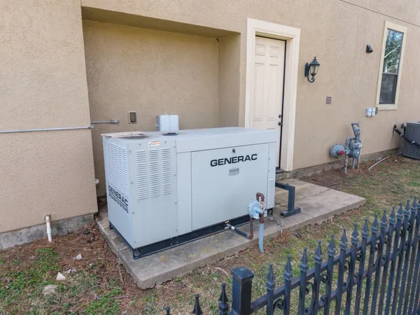 a view of house with swimming pool and large trees