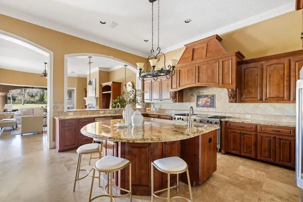 a kitchen with stainless steel appliances granite countertop a sink a stove and a refrigerator