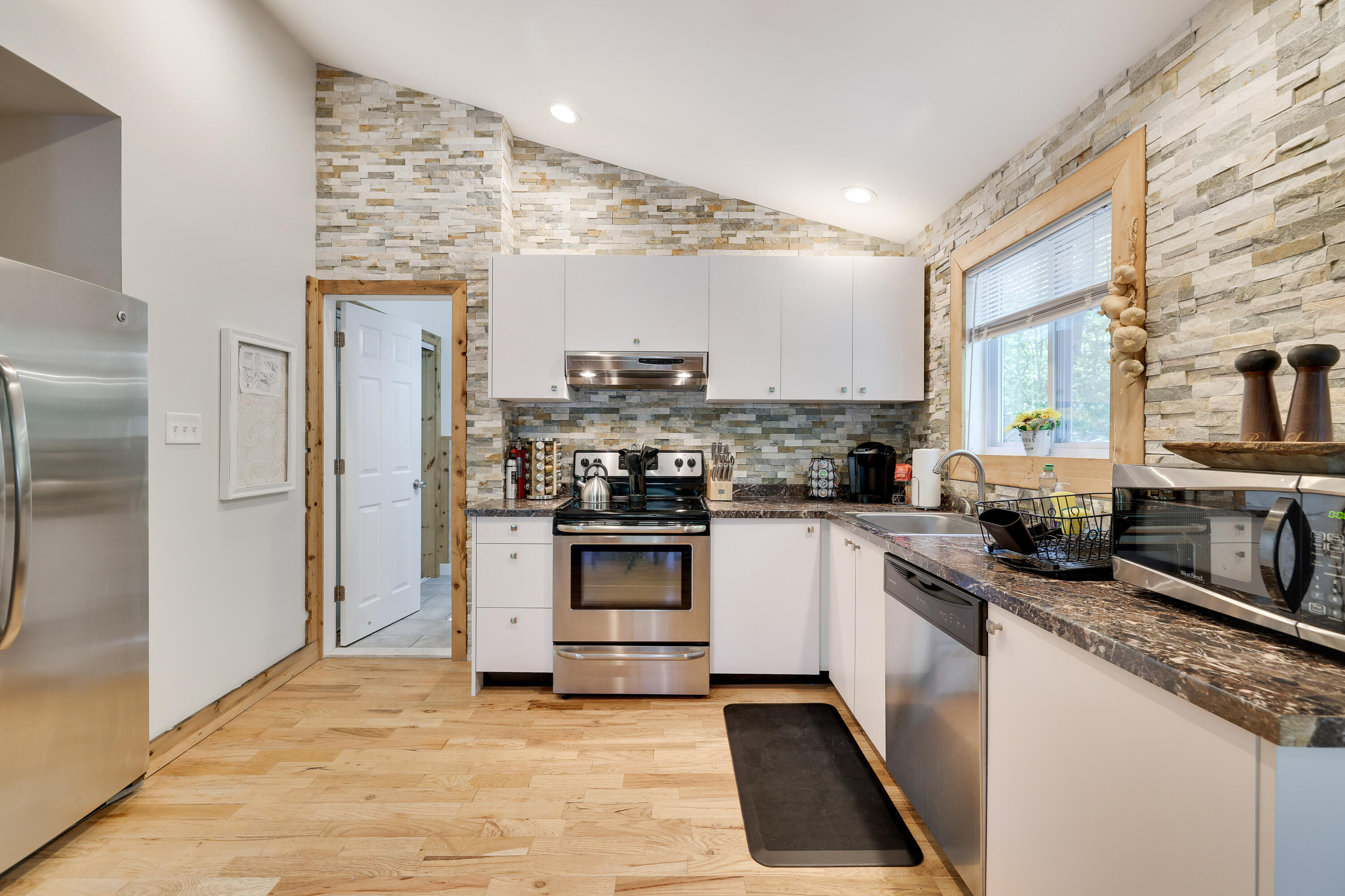 6114 Decker Road Bushkill, PA 18324 - Photo 6 of 65 a kitchen with stainless steel appliances granite countertop a stove a sink and a refrigerator