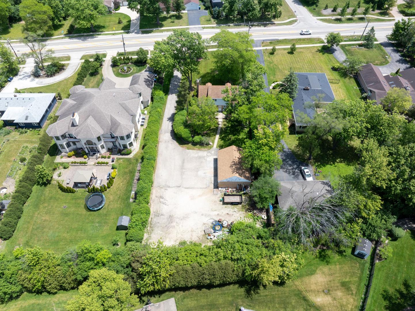 1450 Sanders Road Northbrook, IL 60062 - Photo 5 of 8 an aerial view of a house with yard swimming pool and outdoor seating