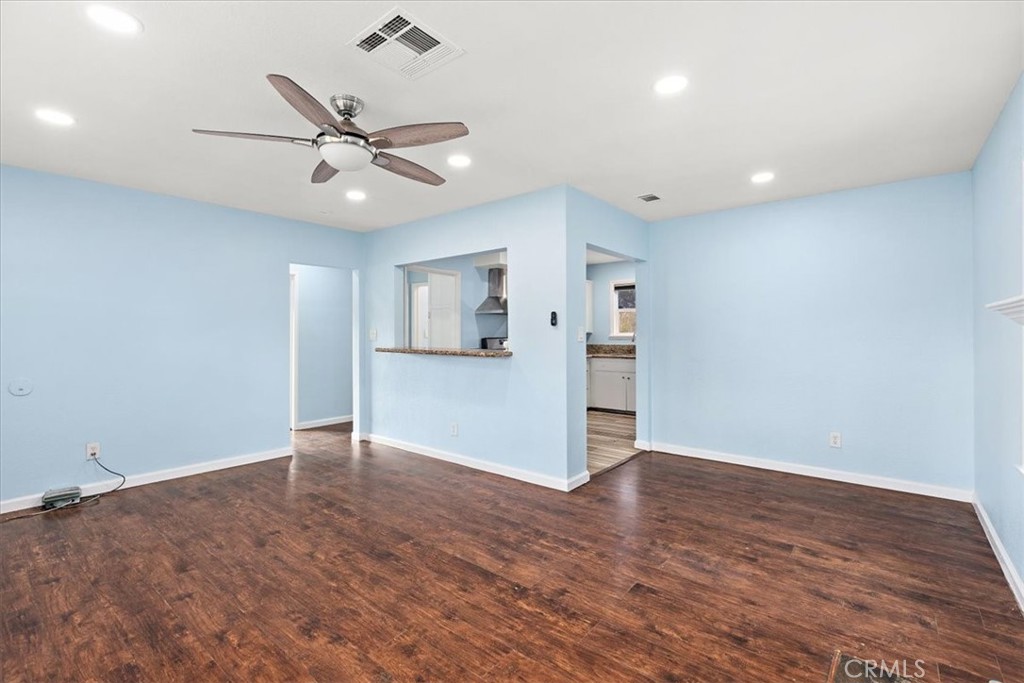 4485 Dwight Avenue Riverside, CA 92507 - Photo 4 of 15 wooden floor in an empty room with a window