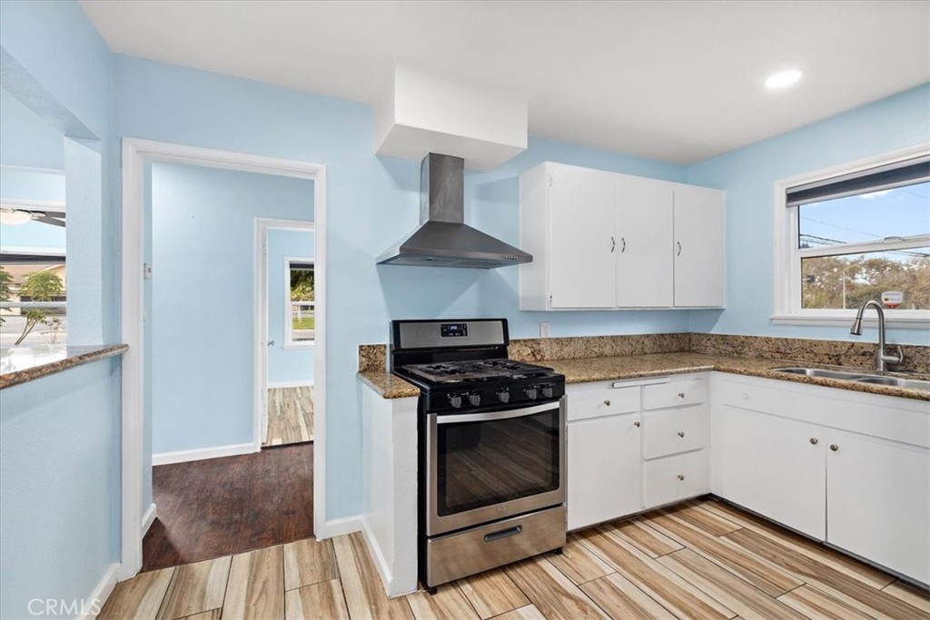 4485 Dwight Avenue Riverside, CA 92507 - Photo 6 of 15 a kitchen with granite countertop a stove and a sink