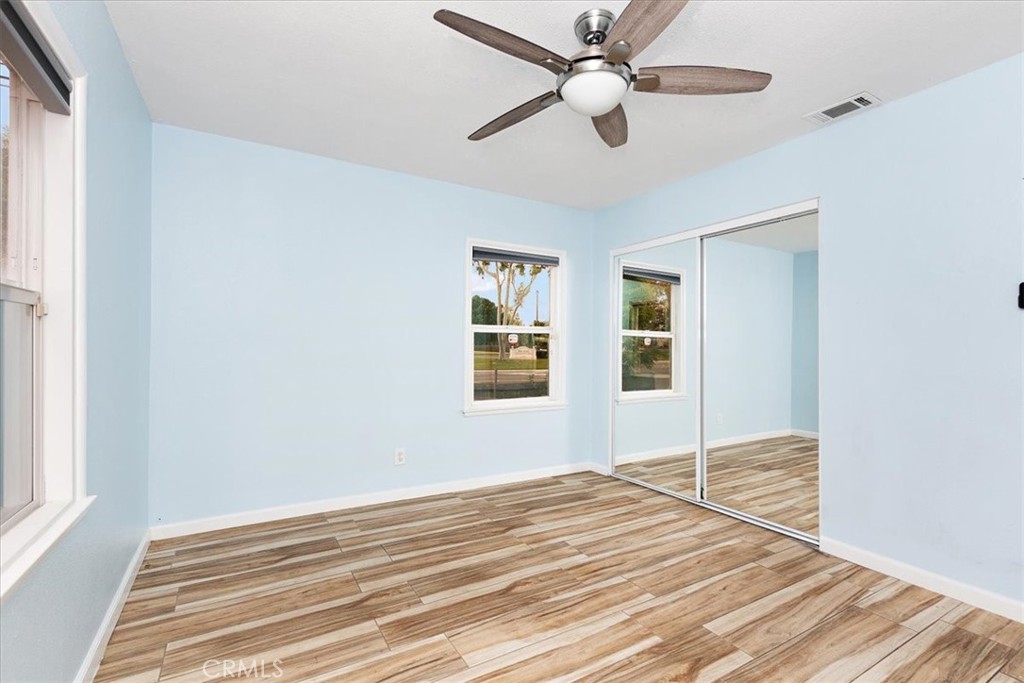 4485 Dwight Avenue Riverside, CA 92507 - Photo 9 of 15 a view of a livingroom with wooden floor and a ceiling fan