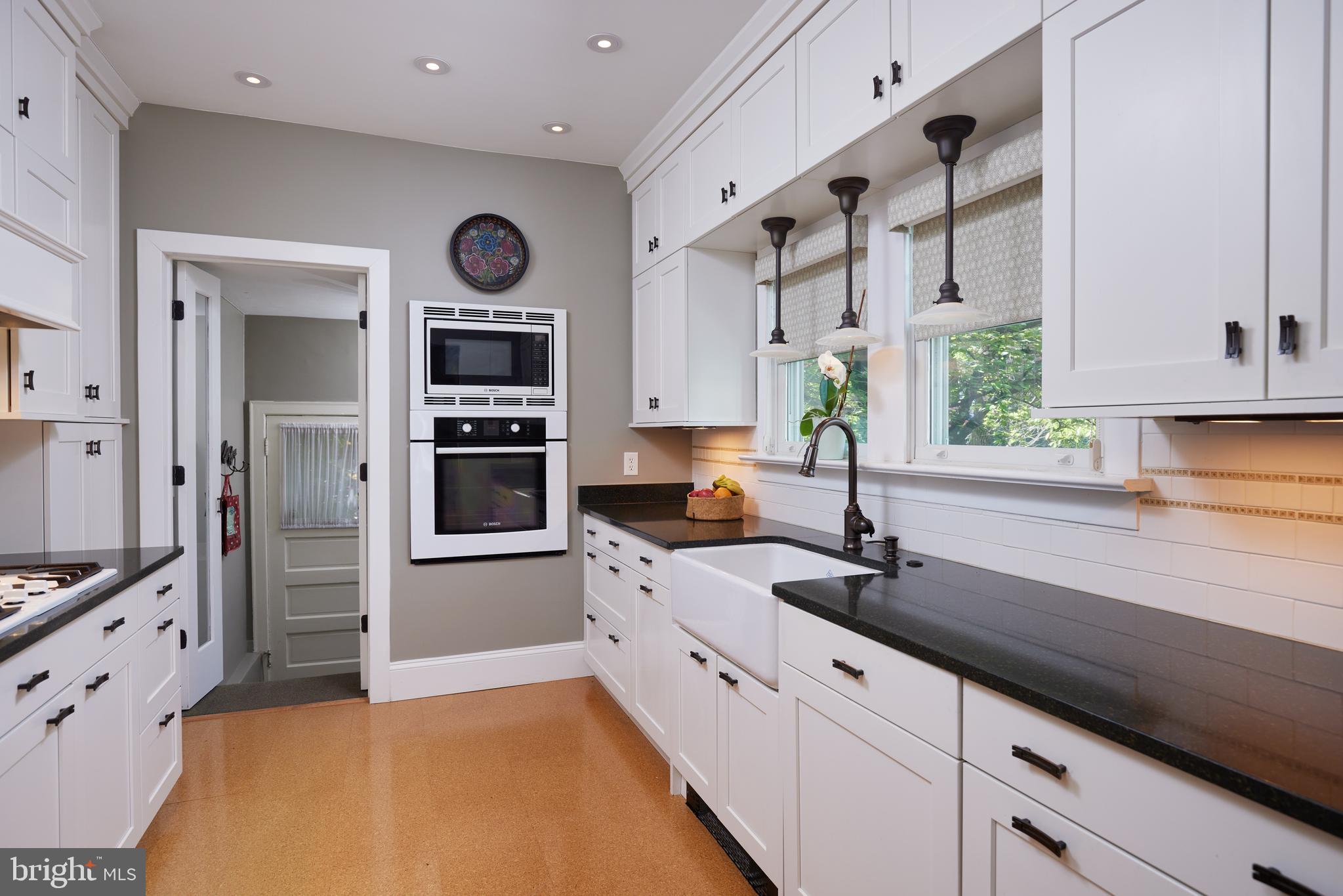 4236 River Road Northwest Washington, DC 20016 - Photo 18 of 44 a kitchen with stainless steel appliances granite countertop a sink and a stove