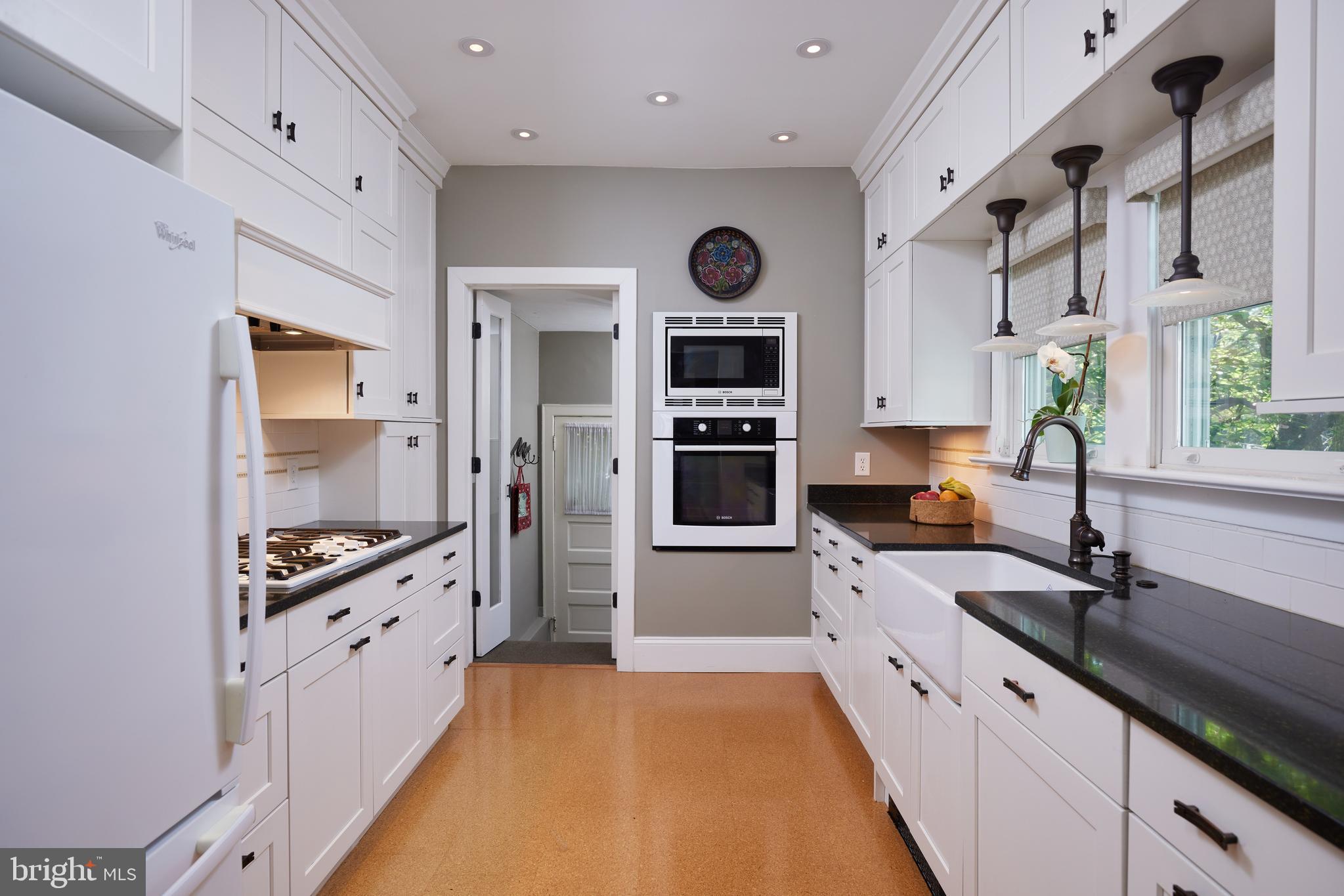 4236 River Road Northwest Washington, DC 20016 - Photo 19 of 44 a large kitchen with stainless steel appliances a sink a stove and a refrigerator